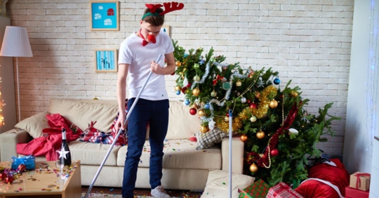 man cleaning post-Christmas party